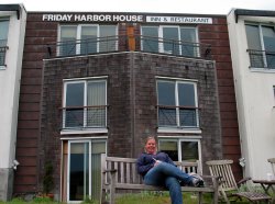 Bekki in front of the Friday Harbor House Inn. Our room is the brown one on the second floor on the right.