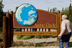 Norm in front of the Arctic Circle sign