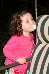 Violet sneakily eating a marshmallow off a stick 1