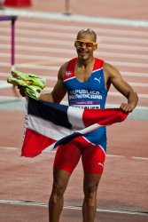 Dominican Republic's Felix Sanchez celebrates his gold medal in the Men's 400m Hurdles
